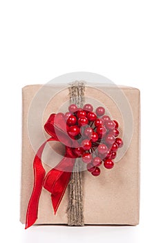 Christmas gift wrapped in craft and decorateed with twine with a