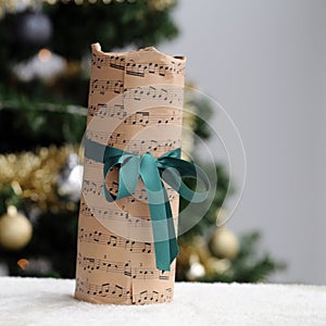 Christmas Gift Wrapped in a Music Themed Paper with Green Ribbon