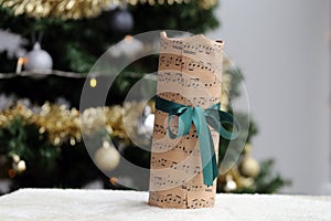 Christmas Gift Wrapped in a Music Themed Paper with Green Ribbon