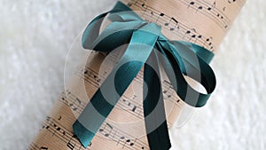 Christmas Gift Wrapped in a Music Themed Paper with Green Ribbon