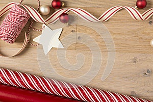 Christmas gift wrapping paper and ribbons supplies on wood background photo