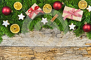 Christmas gifts decoration on fir branches border and wood background