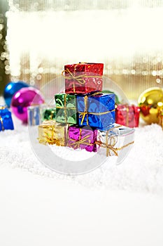 Christmas gifts with baubles and snow