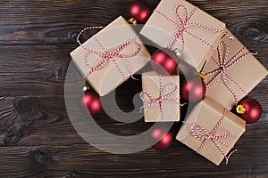 Christmas gifts box presents with red balls on wooden background