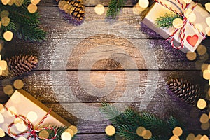 Christmas gifts boxes with fir branches on wooden background top view