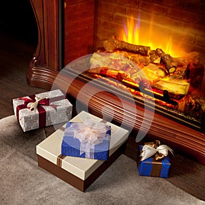 Christmas gifts boxes near fireplace
