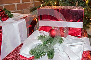 Christmas gifts, Christmas balls, fir branches on the background of gift boxes in sparkling foil