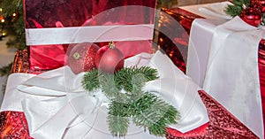 Christmas gifts, Christmas balls, fir branches on the background of gift boxes in sparkling foil