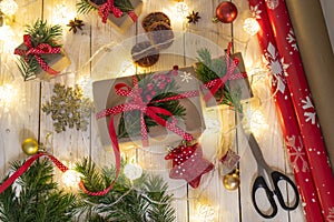 Christmas gifts with christmas decoration on wooden background closeup, gift making