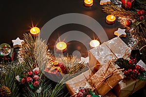 Christmas gifts, christmas tree, candles, colored decor, stars, balls on black background