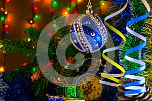 Christmas gifts and clock with Christmas and toy on a tree branch on the background Garland