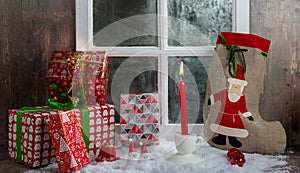 Christmas gifts decoration near the rustic window