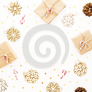 Christmas gifts, decorations and candy canes on white background. Flat lay, top view. Frame composition with copy space