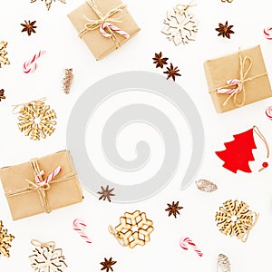 Christmas gifts, decorations and candy canes on white background. Flat lay, top view. Winter frame composition