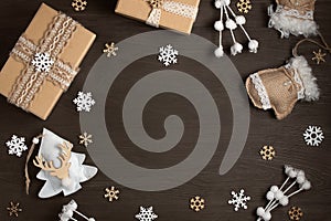 Christmas gifts and decorations made of natural materials on a dark wooden table with a copy space. Mockup for cards and