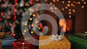 Christmas gifts in front of fireplace - static camera
