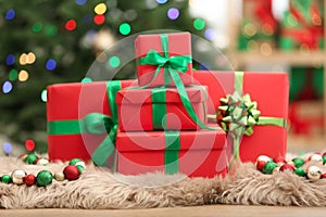 Christmas gifts on fuzzy rug against background