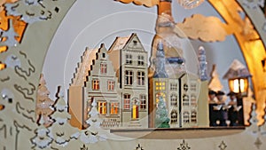 Christmas gifts interior tree and New Year german wooden house toys blinking room lights and fireplace