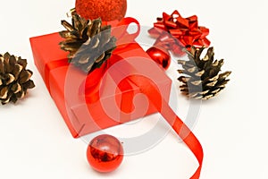 Christmas gifts present on white background. Classic red wrapped gift box with ribbon bow and festive holiday