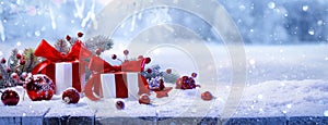 Christmas Gifts With Red Bows On A Winter Forest Background