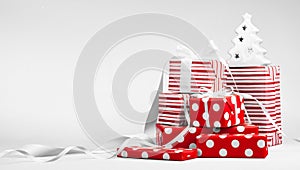 Christmas gifts in red paper with white ribbons