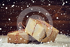 Christmas gifts with red ribbon in snowing