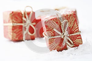 Christmas gifts with red wrapping and bows.