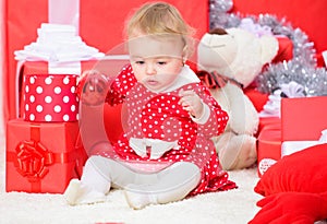 Christmas gifts for toddler. Things to do with toddlers at christmas. Little baby girl play near pile of gift boxes