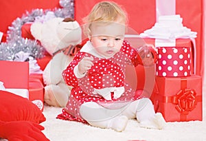 Christmas gifts for toddler. Things to do with toddlers at christmas. Little baby girl play near pile of gift boxes