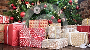 Christmas gifts under the Christmas tree red and wooden toys brick wall. new year 2019