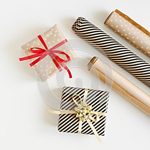 Christmas gifts wrapped in brown kraft paper and paper rolls for DIY wrapping