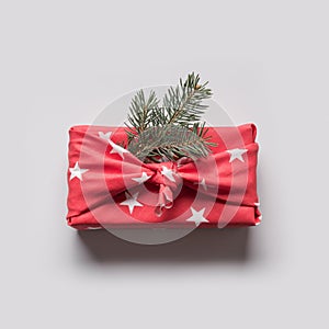 Christmas gifts wrapped in red textile. Zero waste. Xmas. Furoshiki style