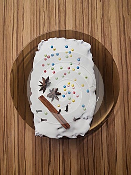 Christmas giner bread cake with white glaze decorated with cinamon stick photo