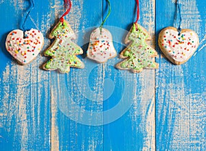 Christmas ginger biscuits with icing on a blue background