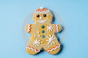 Christmas Gingerbread angel shape on blue background. Flat lay