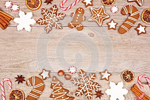 Christmas gingerbread cookies, candy and baking items, double border on a wood background