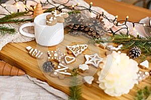 Christmas  gingerbread cookies, coffee, pine cones, fir branches and warm lights