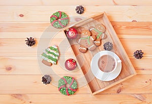 Christmas gingerbread cookies and cup of homemade hot chocolate on tray. Top view