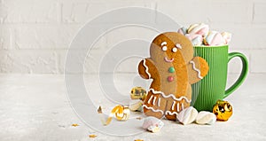 Christmas gingerbread cookies and a cup of hot chocolate with marshmallows on a light background. Festive food. Christmas concept