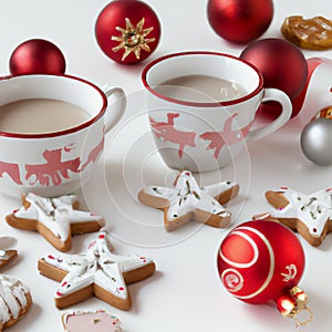 Christmas gingerbread cookies, with festive mugs for hot chocolate, Christmas decor and baubles, white background