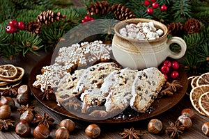 Christmas gingerbread  cookies with holiday  stollen and hot chocolate drink in mug with marshmallow