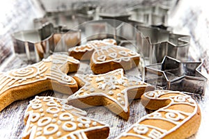 Christmas gingerbread cookies and metal cookie cutters on white