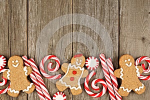 Christmas gingerbread cookies, and peppermints on rustic wood photo