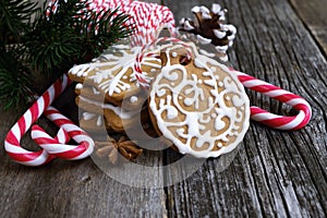 Christmas gingerbread cookies on a wooden table with candy canes