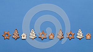 Christmas gingerbread in different shapes on a blue background