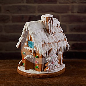 Christmas gingerbread house decorated with sugar icing and colorful candy