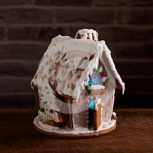 Christmas gingerbread house decorated with sugar icing and colorful candy