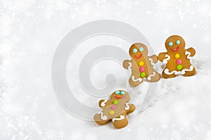 Christmas gingerbread men on the background of snow