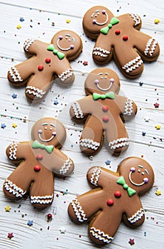 Christmas gingerbread men  on a white wooden background