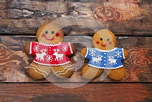 Christmas gingerbread men on wooden background.